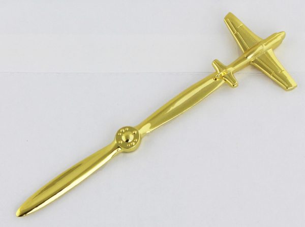 gold colored letter opener with airplane on one end